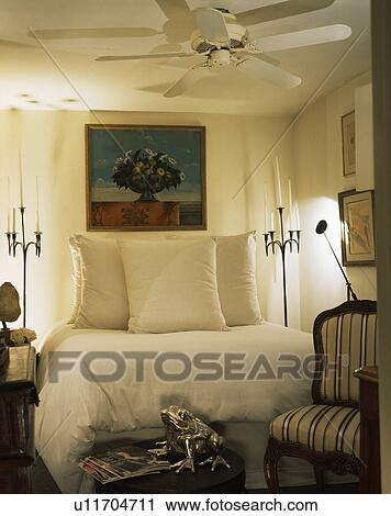 Picture Above Bed With White Pillows And Duvet In White Bedroom