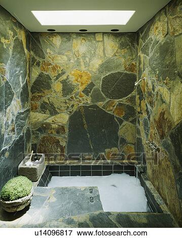 Polished stone walls above modern spa bathtub View Large Photo Image Stock Photo - Polished stone walls above modern spa bathtub . Fotosearch