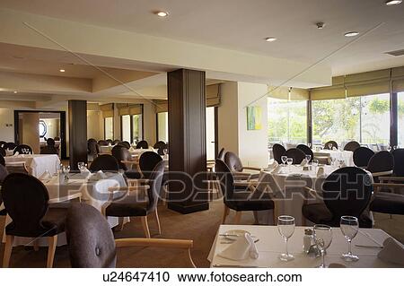 Stock Image - Restaurant decorated in cool monochromatic scheme.. Fotosearch