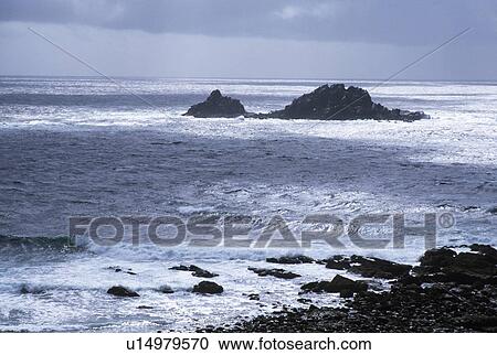 Stock Image - Rocks in grey seas at Hartland Point in Cornwall. Fotosearch