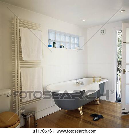Rolltop bath in modern white bathroom with vertical radiator View Large Photo Image Stock Image - Rolltop bath in modern white bathroom with vertical radiator. Fotosearch