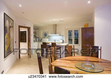 Round diningroom table in tropical hardwood at one end of large kitchen diningroom. View Large Photo Image Stock Image - Round diningroom table in tropical hardwood at one end of large kitchen diningroom.. Fotosearch