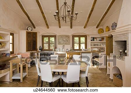 Stock Image - Round table in rustic spanish diningroom. Fotosearch