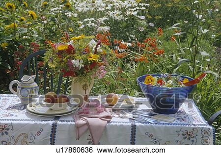 Salad in blue bowl with vase of fresh flowers on table in garden View Large Photo Image Stock Photograph - Salad in blue bowl with vase of fresh flowers on table in garden. Fotosearch