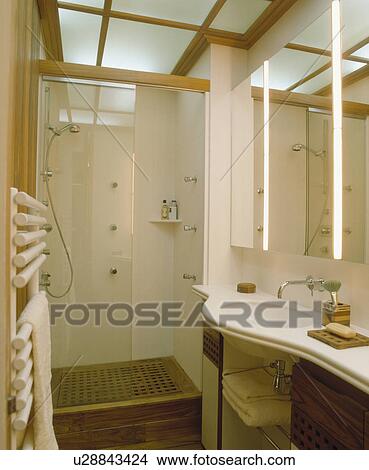 Small modern cream bathroom with shower cabinet View Large Photo Image Picture - Small modern cream bathroom with shower cabinet. Fotosearch