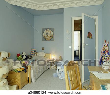 Soft toys piled on bed in child's pastel blue bedroom View Large Photo Image Picture - Soft toys piled on bed in child's pastel blue bedroom. Fotosearch