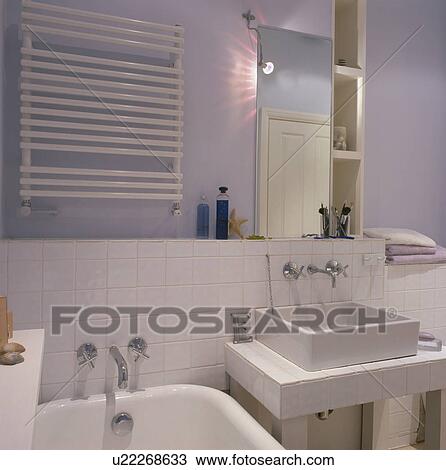 Stock Image - Square ceramic basin on vanity unit in small modern bathroom. Fotosearch