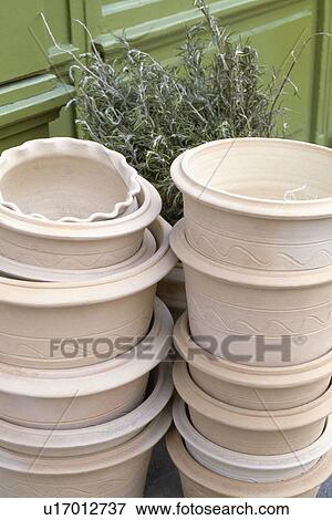 Stacks of pots with a bunch of cut rosemary View Large Photo Image Stock Photo - Stacks of pots with a bunch of cut rosemary. Fotosearch