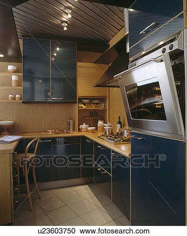 Stainless steel oven in modern kitchen with black units and ceiling spotlights View Large Photo Image Stock Image - Stainless steel oven in modern kitchen with black units and ceiling spotlights. Fotosearch