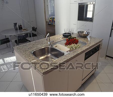 Stainless Steel Sink And Dishwasher In Granite Topped Island Unit