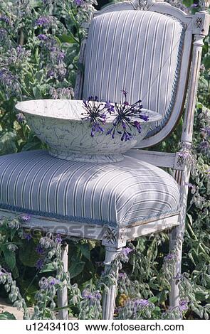 Still-Life of blue+white bowl on pale grey striped upholstered chair View Large Photo Image Stock Image - Still-Life of blue+white bowl on pale grey striped upholstered chair. Fotosearch