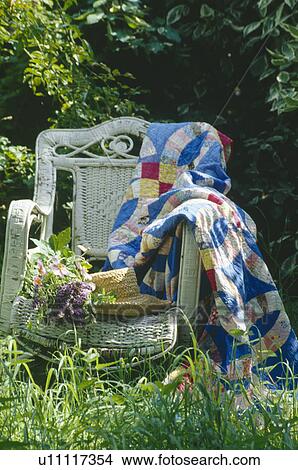 Still-life of colourful patchwork quilt on white wicker armchair View Large Photo Image Picture - Still-life of colourful patchwork quilt on white wicker armchair. Fotosearch
