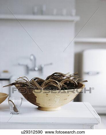 Stock Image - Still-Life of copper bowl with wicker bangles. Fotosearch