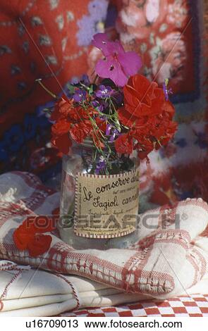Still-life of red and pink geraniums in old jam jar on red+white cloth View Large Photo Image Stock Image - Still-life of red and pink geraniums in old jam jar on red+white cloth. Fotosearch