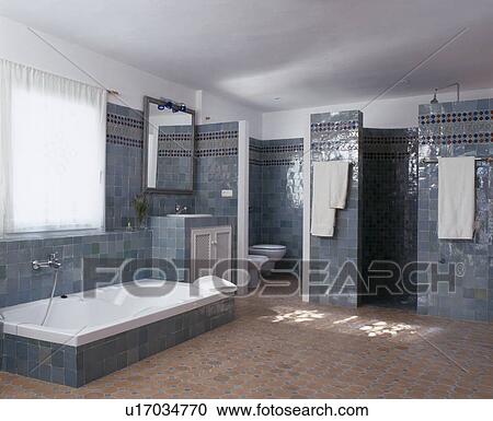 Sunken bath in blue tiled Spanish bathroom with tiled floor View Large Photo Image Stock Image - Sunken bath in blue tiled Spanish bathroom with tiled floor. Fotosearch