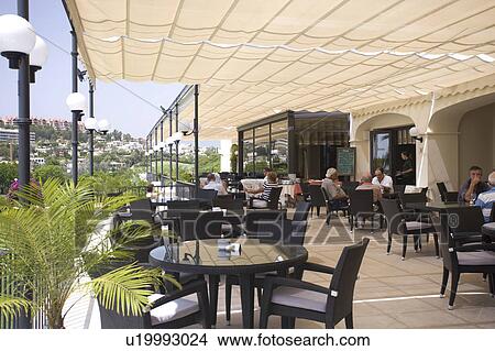 Picture - Tables arranged under awning and overlooking the village.. Fotosearch