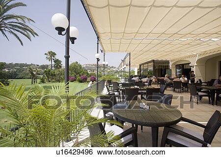 Stock Photograph - Tables arranged under awning and overlooking . Fotosearch