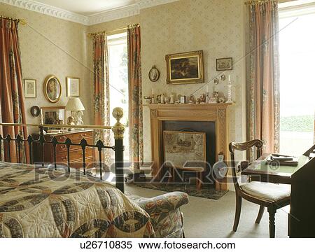 Stock Photography - Traditional country bedroom with fireplace. Fotosearch