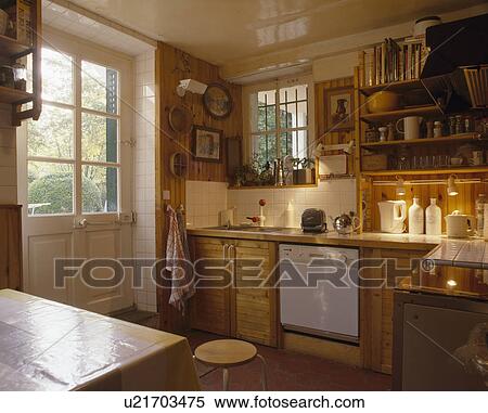 Traditional country kitchen with half-glazed door and wooden units View Large Photo Image Stock Photography - Traditional country kitchen with half-glazed door and wooden units. Fotosearch