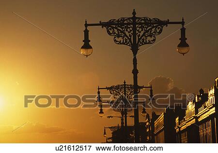 Victorian streetlamps against yellow sunset on the promenade at Hove in West Sussex View Large Photo Image Stock Photo - Victorian streetlamps against yellow sunset on the promenade at Hove in West Sussex. Fotosearch