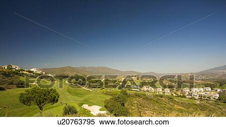 View across golf course to urbanization with the mountains in the background. View Large Photo Image Stock Photography - View across golf course to urbanization with the mountains in the background.. Fotosearch