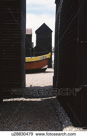 View between wooden huts of boat on the beach at Hastings in Sussex View Large Photo Image Stock Photo - View between wooden huts of boat on the beach at Hastings in Sussex. Fotosearch
