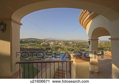 View through arch on terrace towards swimming pool and over the rest of the estate. View Large Photo Image Stock Image - View through arch on terrace towards swimming pool and over the rest of the estate.. Fotosearch