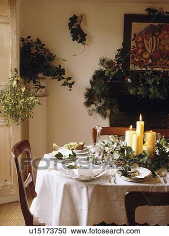 White cloth on table set for Christmas dinner with fresh foliage decorations View Large Photo Image Stock Image - White cloth on table set for Christmas dinner with fresh foliage decorations. Fotosearch