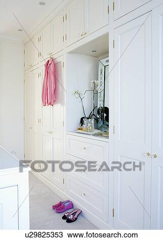 White fitted storage cupboards in traditional dressing room View Large Photo Image Stock Image - White fitted storage cupboards in traditional dressing room. Fotosearch