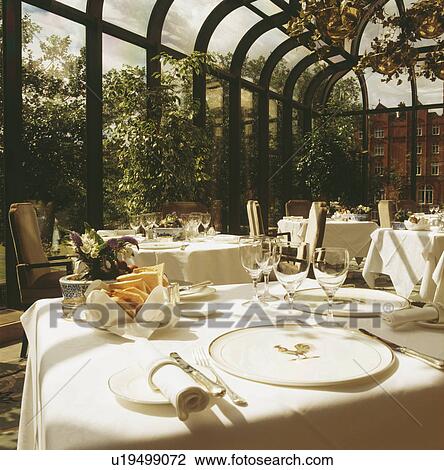 White linen cloths on table in conservatory restaurant View Large Photo Image Stock Image - White linen cloths on table in conservatory restaurant. Fotosearch