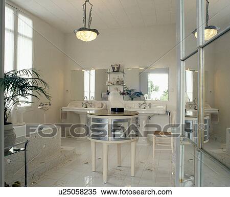 White mirror and mosaic floor in thirties-style white bathroom with chrome table View Large Photo Image Stock Photography - White mirror and mosaic floor in thirties-style white bathroom with chrome table. Fotosearch