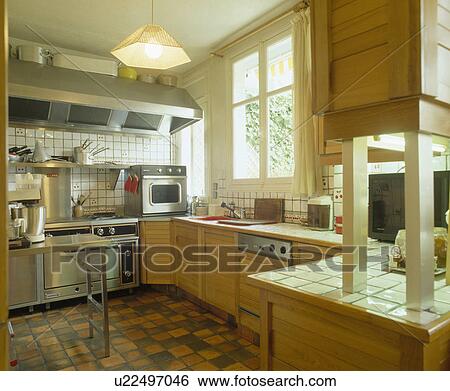 White tiled worktops and wooden units in eighties kitchen View Large Photo Image Stock Photograph - White tiled worktops and wooden units in eighties kitchen. Fotosearch