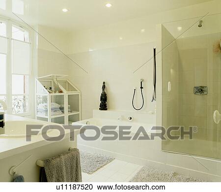 Stock Image - White townhouse bathroom with glass shower cabinet. Fotosearch