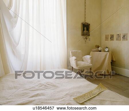 White voile curtains in bedroom with marbled paint effect walls and chair with cream loosecover View Large Photo Image Stock Photo - White voile curtains in bedroom with marbled paint effect walls and chair with cream loosecover. Fotosearch