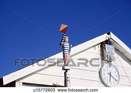 Wooden sailor figure and clock on white beach hut at Mudeford in Hampshire View Large Photo Image Stock Image - Wooden sailor figure and clock on white beach hut at Mudeford in Hampshire. Fotosearch