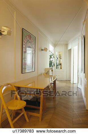 Yellow chair and trestle table in narrow hakll corridor with parquet flooring View Large Photo Image Stock Image - Yellow chair and trestle table in narrow hakll corridor with parquet flooring. Fotosearch