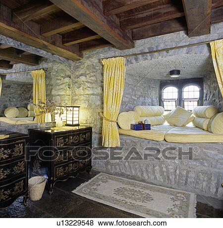 Yellow cushions on stone window seat in Irish castle View Large Photo Image Stock Photo - Yellow cushions on stone window seat in Irish castle. Fotosearch