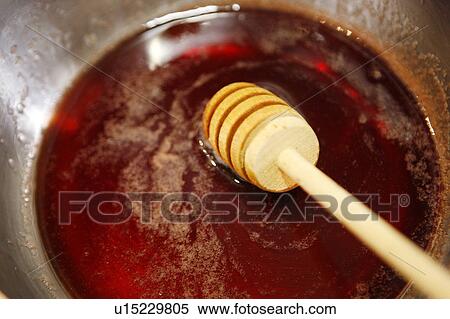 Stock Photography - Adding Honey to Raspberry sauce. Fotosearch