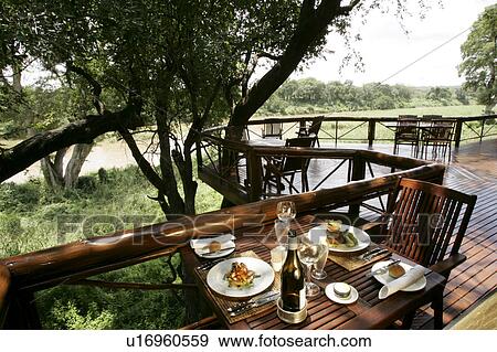 Stock Photo - Al fresco dining area at the Tinga Legends Game Lodge, South Africa. Fotosearch