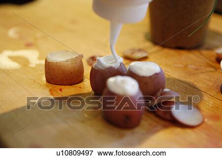Stock Photo - Baby New Potatoes with cream. Fotosearch