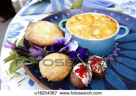 Stock Photo - Baked Herbed Eggs with Baby New Potatoes. Fotosearch