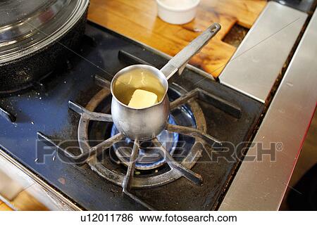 Stock Photograph - Block of Butter in Saucepan. Fotosearch