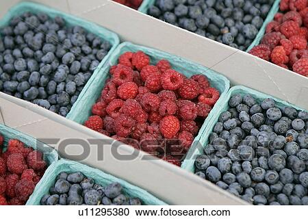 Stock Image - Blueberries and Raspberries at Farmers Market. Fotosearch