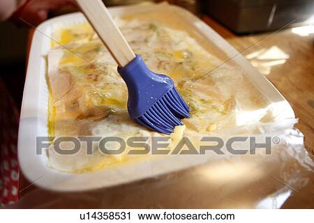 Brushing Wax Paper with butter View Large Photo Image Stock Image - Brushing Wax Paper with butter. Fotosearch