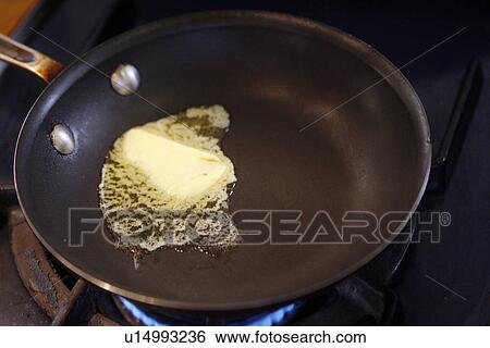 Stock Photograph - Butter melting in Pan. Fotosearch