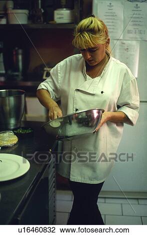 Stock Image - Chef cooking in the kitchen. Fotosearch