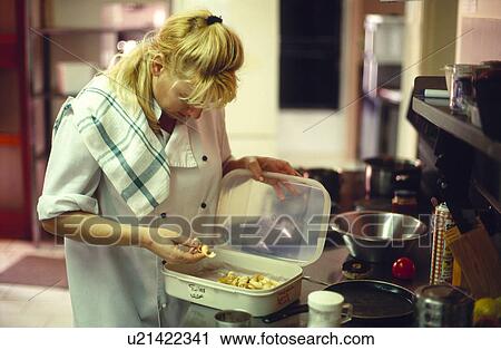 Stock Image - Chef in kitchen with Tuiles. Fotosearch