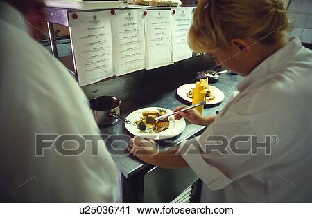 Stock Image - Chef preparing food in kitchen. Fotosearch