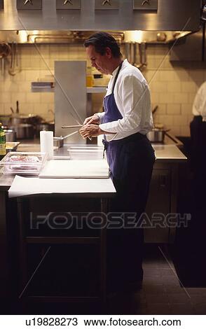 Chef sharpening knife View Large Photo Image Stock Image - Chef sharpening knife. Fotosearch