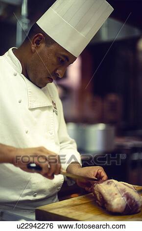 Stock Photograph - Chef Slicing meat. Fotosearch